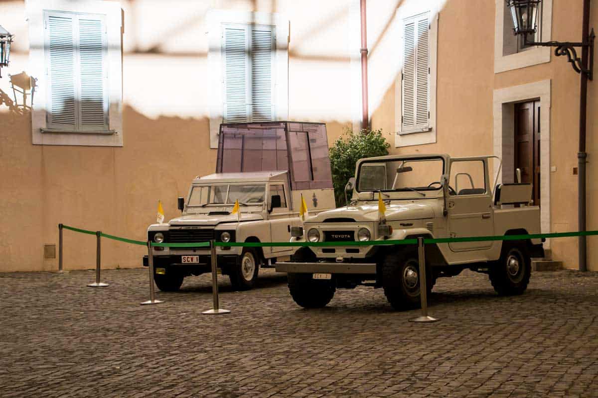 Two of the Pope mobils jeeps parked behind a rope barrier outside the Pope's summer residence.