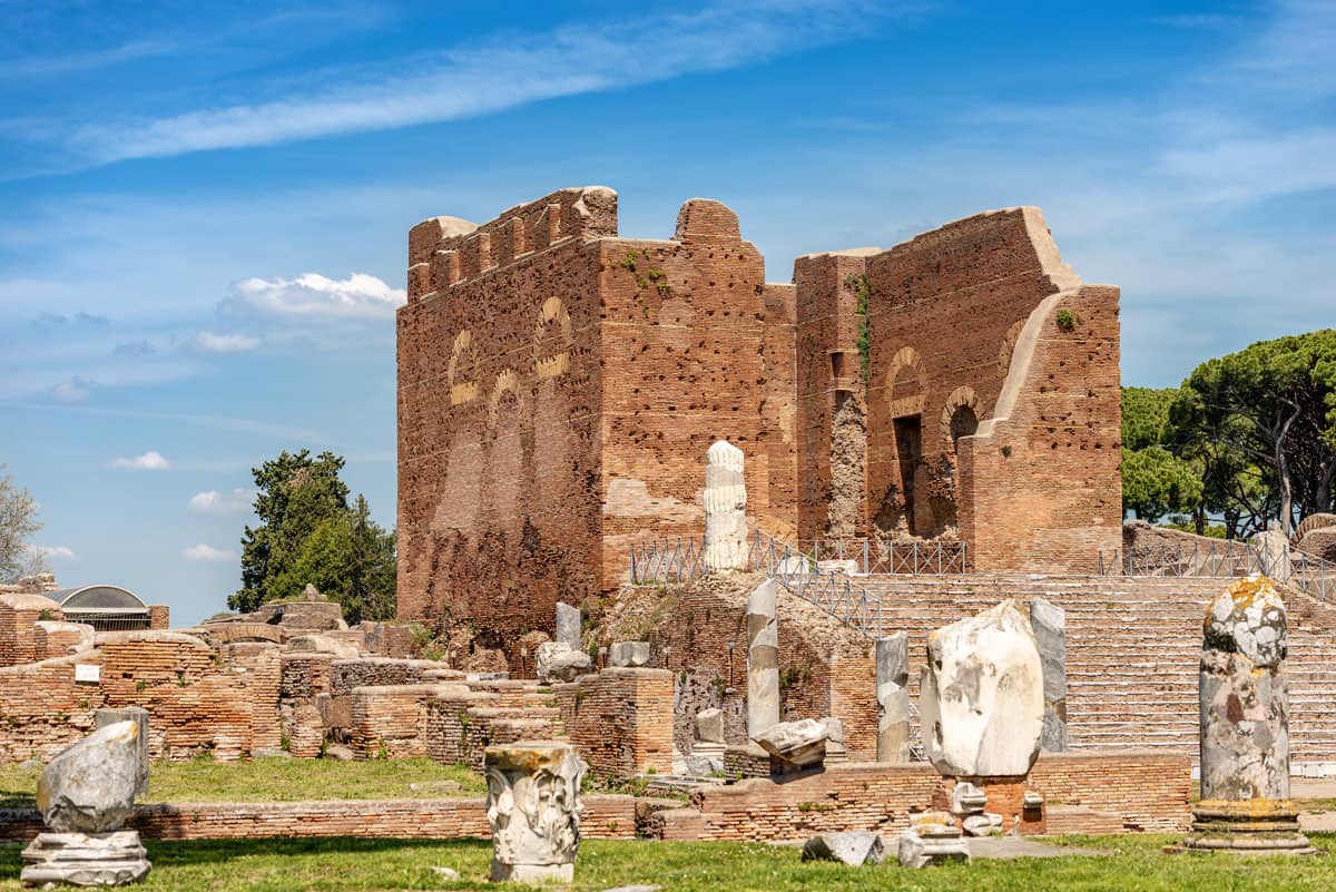Stone ruins of an ancient temple at Ostia Antica in Italy on a sunny day.