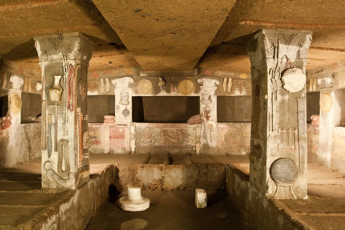 An ancient tomb in Rome with paintings and carvings on the walls.