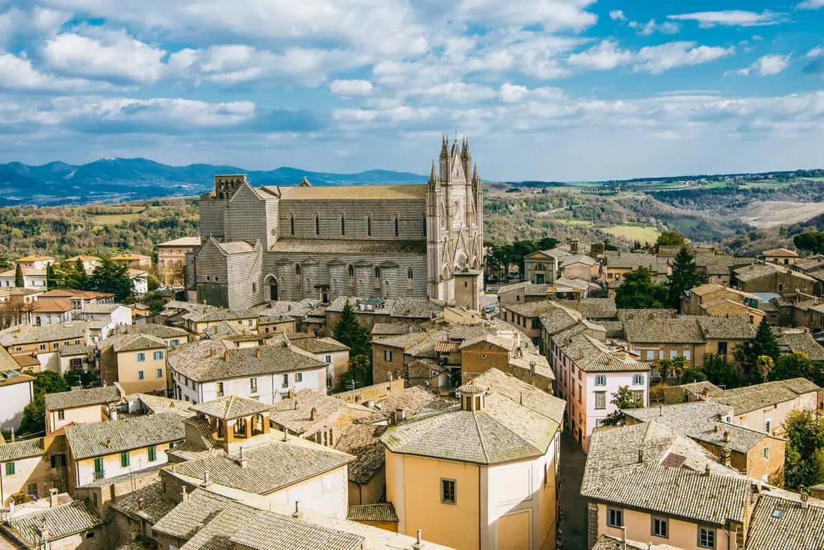 The cathedral of Orvieto rises from the small medieval town in the Italian countryside.