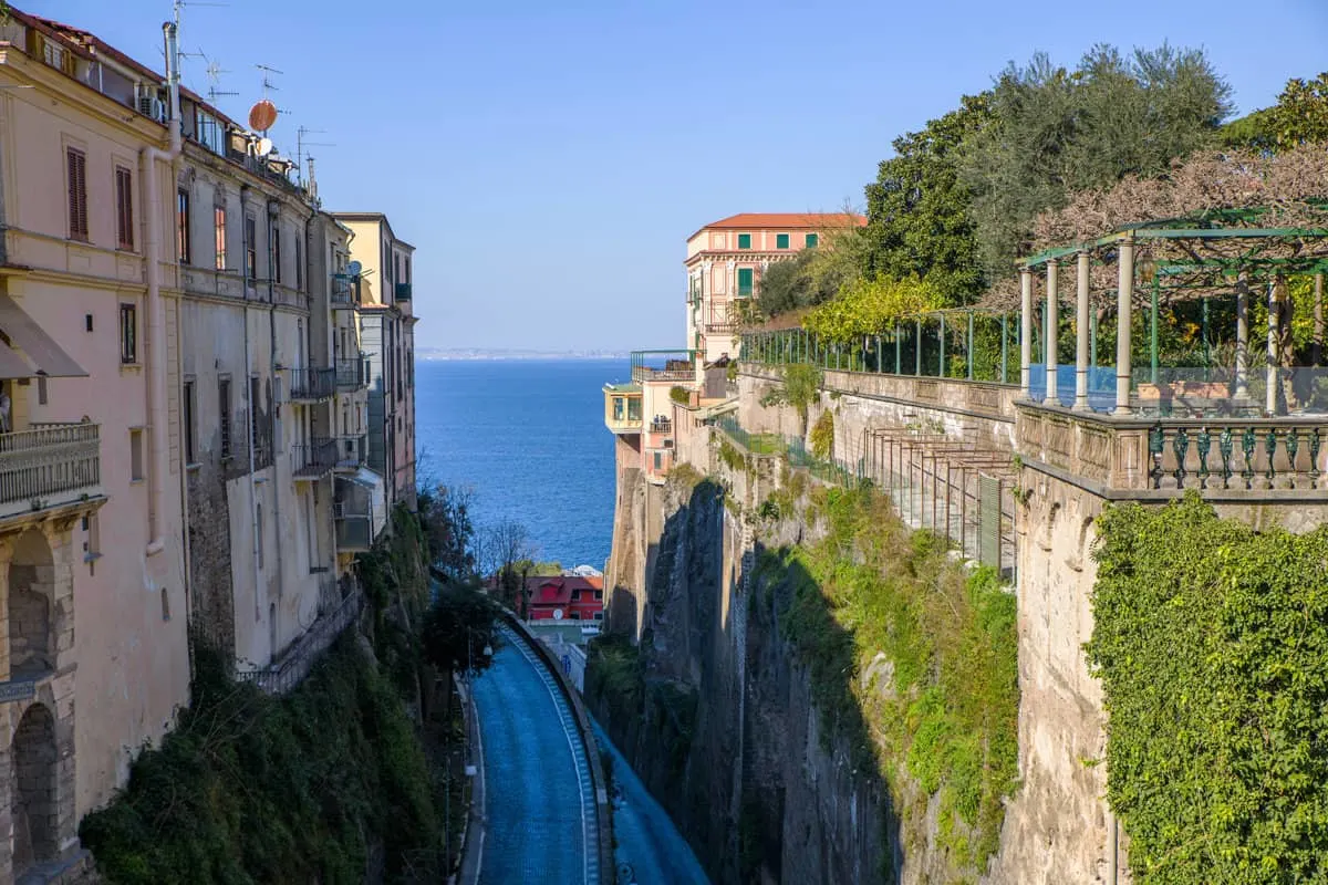 Narrow roads run between buildings with a view over the sea on the Italian coast in Sorrento.