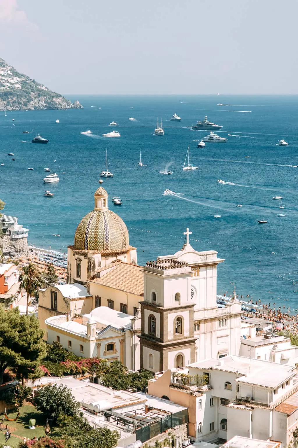 Italian town on the Amalfi coast with lots of boats out on the water.