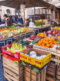 Vendors selling fruit and vegetable at the outdoor market in Rome.