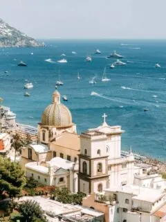Italian town on the Amalfi coast with lots of boats out on the water.