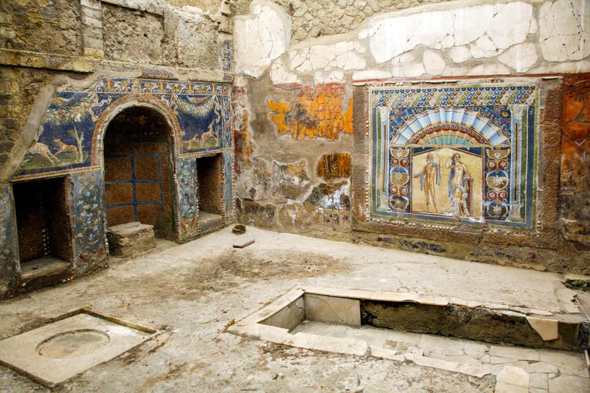 Colourful mosaics on the walls of the ruins of the House court in ancient Herculaneum roman city in Italy.