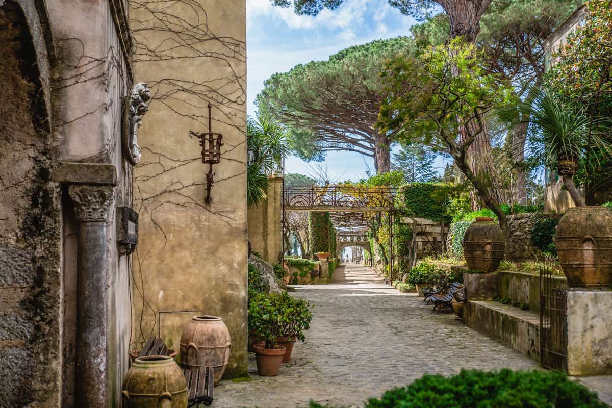 An historic Italian stone villa with large trees and landscaped gardens