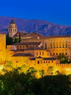 The Alhambra palace lit up at night.
