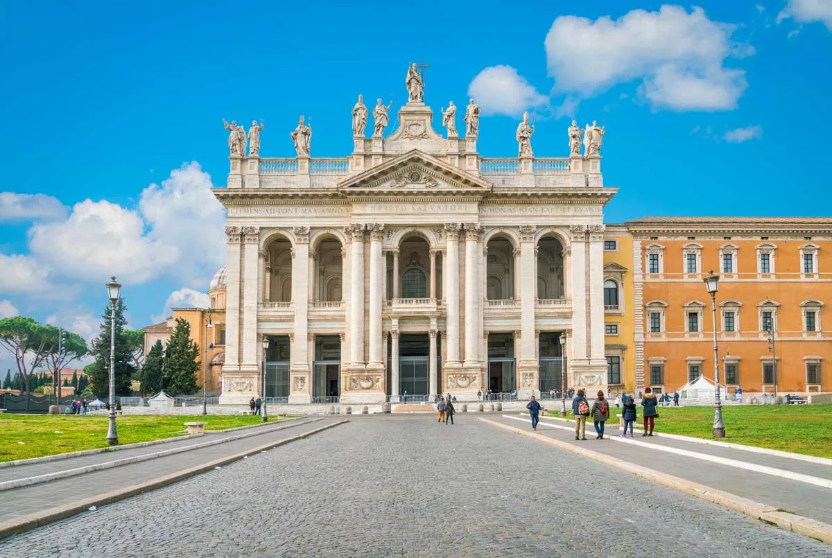 Tourists in front of the Basilica of Saint John Lateran in Rome