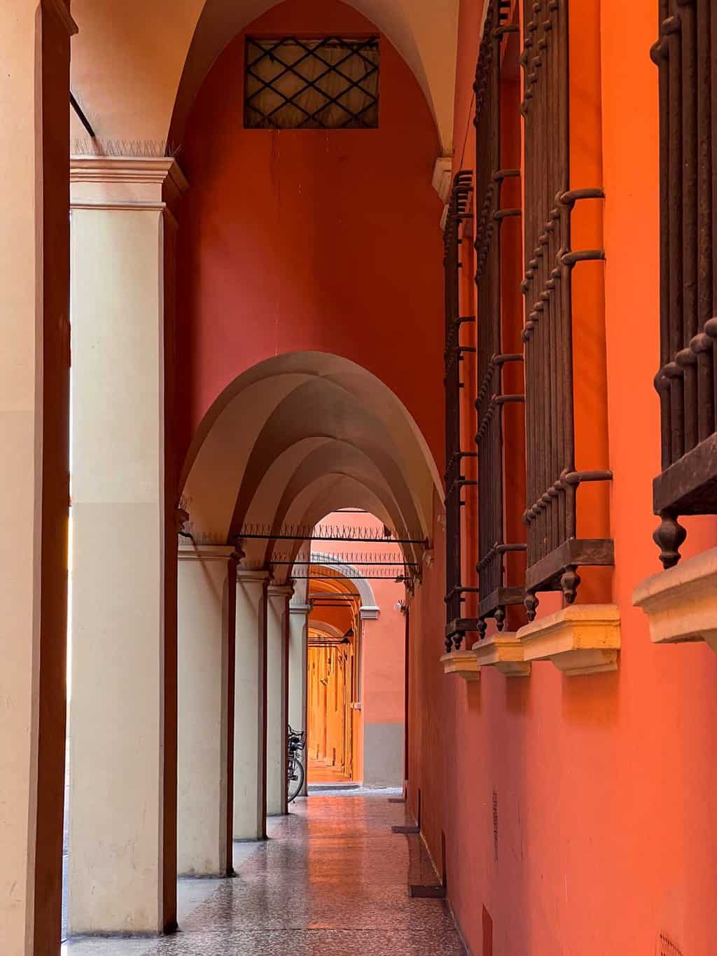 The arched porticos of Bologna in deep orange colours. 
