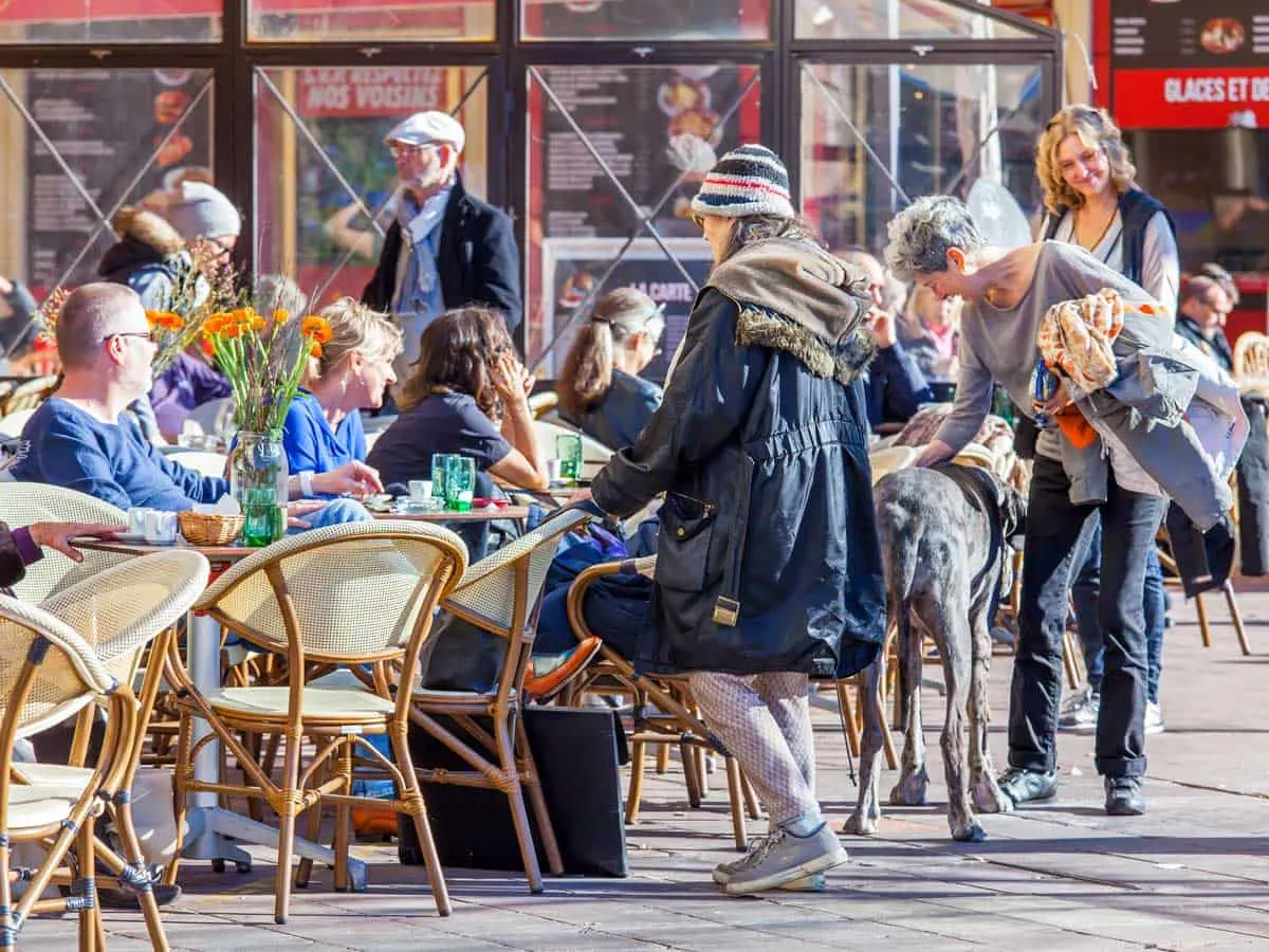 People enjoying an outdoor cafe in Nice on a sunny winters day.