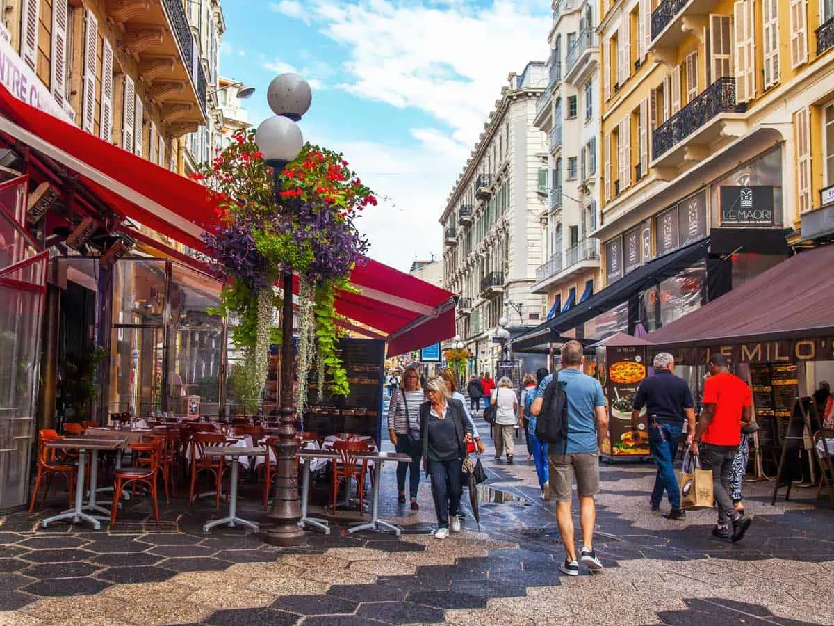 People walk through the old town of Nice. 