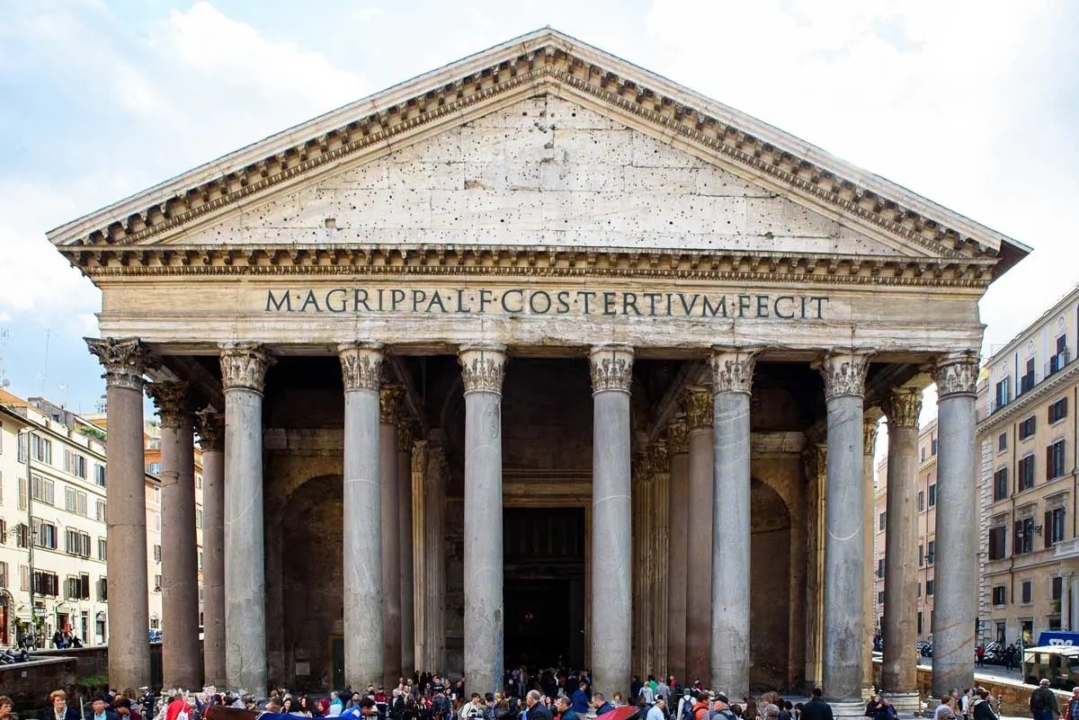 Exterior of the Pantheon in Rome with lots of tourists out front. 