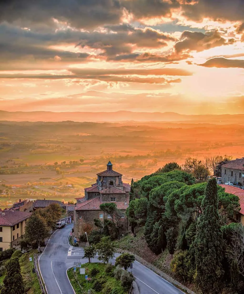 View over Cortona and the Tuscan countryside at sunset. 