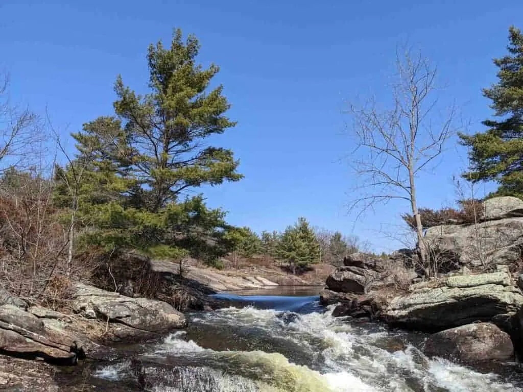 Water cascades over rocks in the wilderness. 