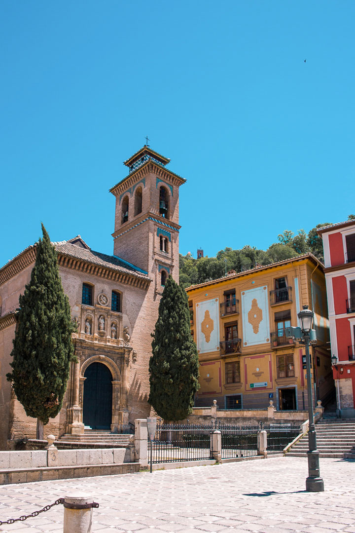A typical plaza with a church in Granada Spain. 