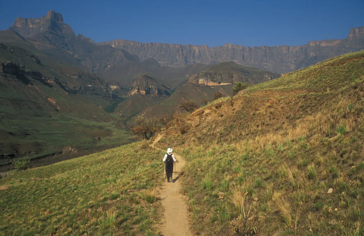 Hiker walking the trails of Drakensberg Mountain