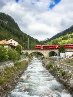 Scenic-train-ride-in-switzerland-through-mountains-charming-towns-and-sparkling-creeks-