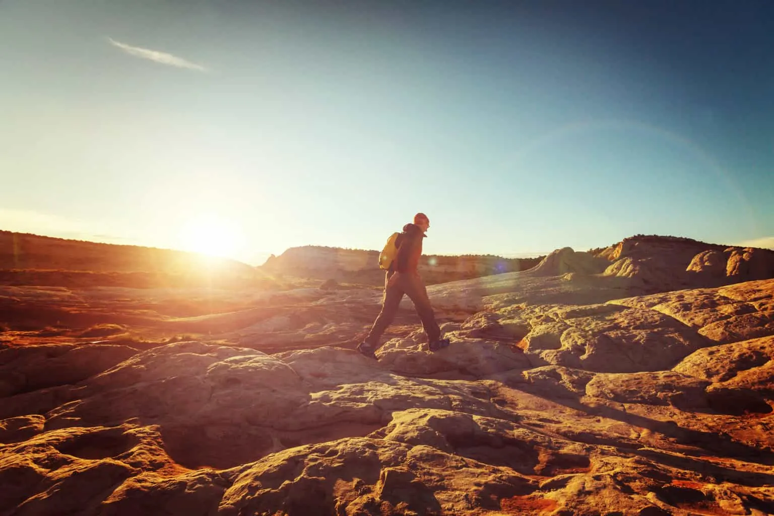 A hiker on a snowy mountain trail, the hardest winter hiking on this list