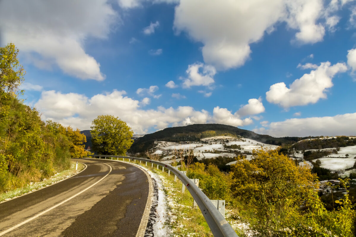 A road in the hills of Tuscany (Italy) with the first snow of winter