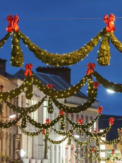 festive holiday street lights hung over city street in Galway, Ireland