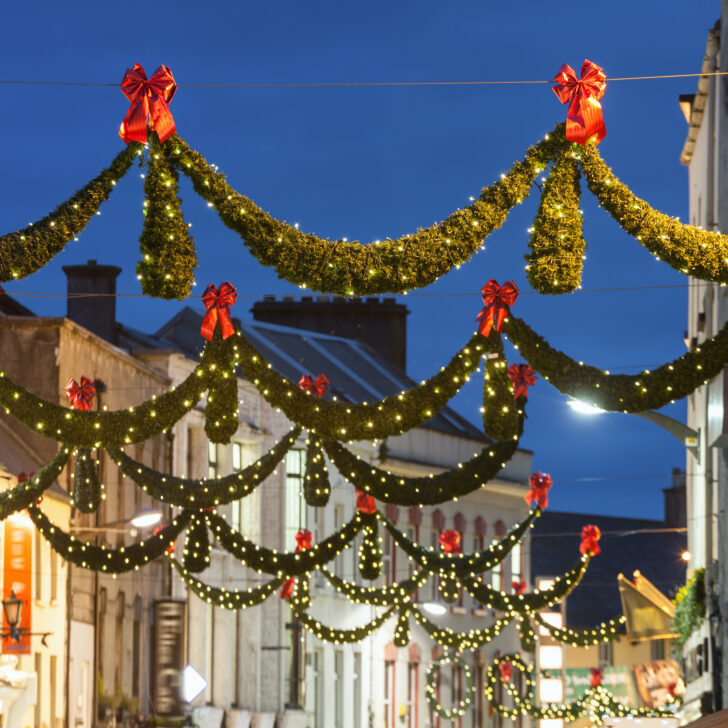 festive holiday street lights hung over city street in Galway, Ireland