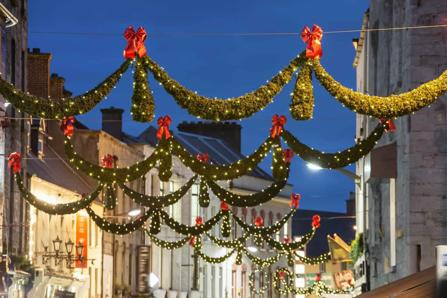 Christmas street lights and garlands strung across a street in Ireland