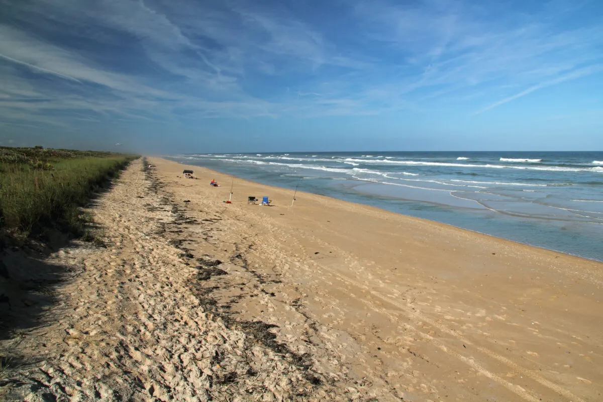 Beach at Gulf Islands National Seashore. Fishing poles and chairs in background