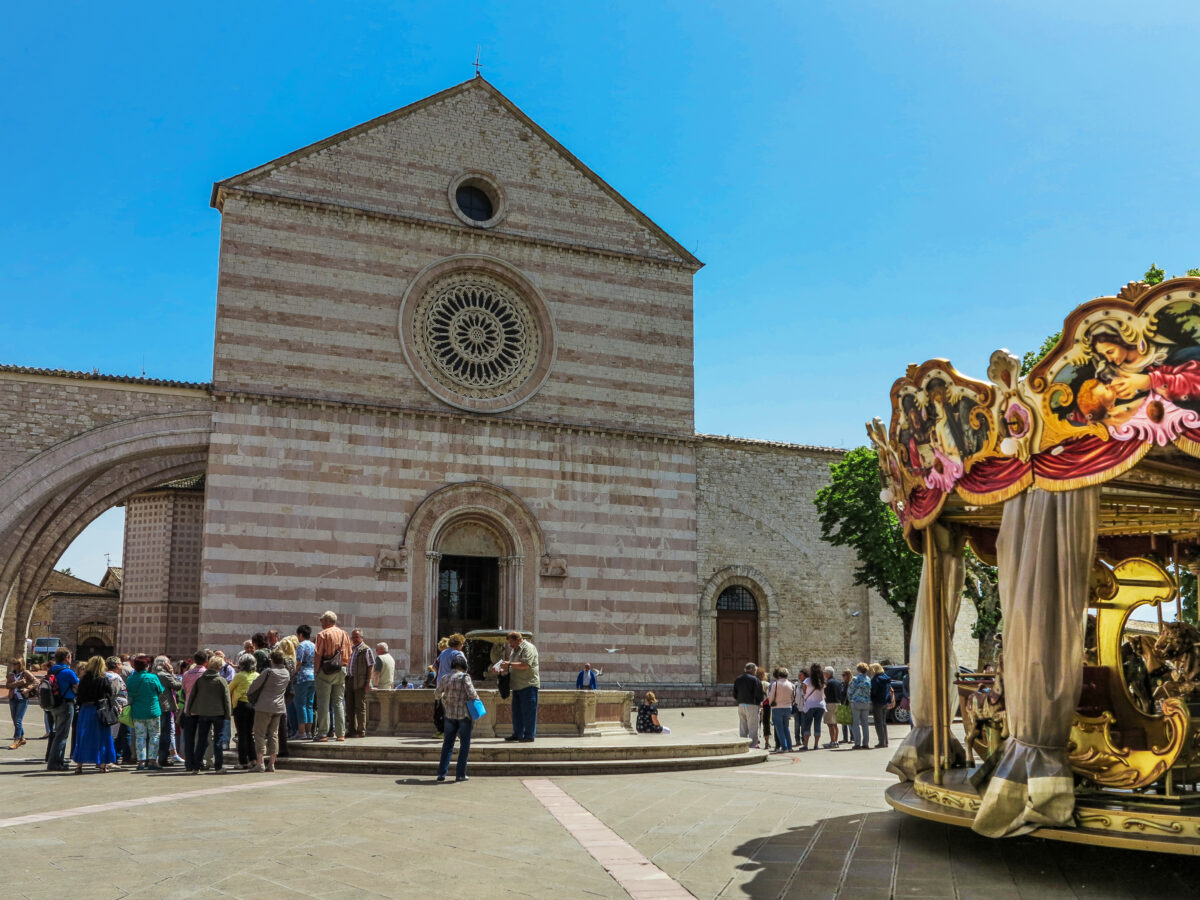 tourists in front of Basilica di Santa Chiara in Assisi Italy