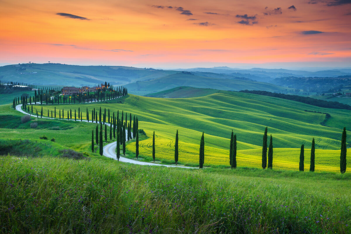 Tuscan landscape with rolling green hills at sunset