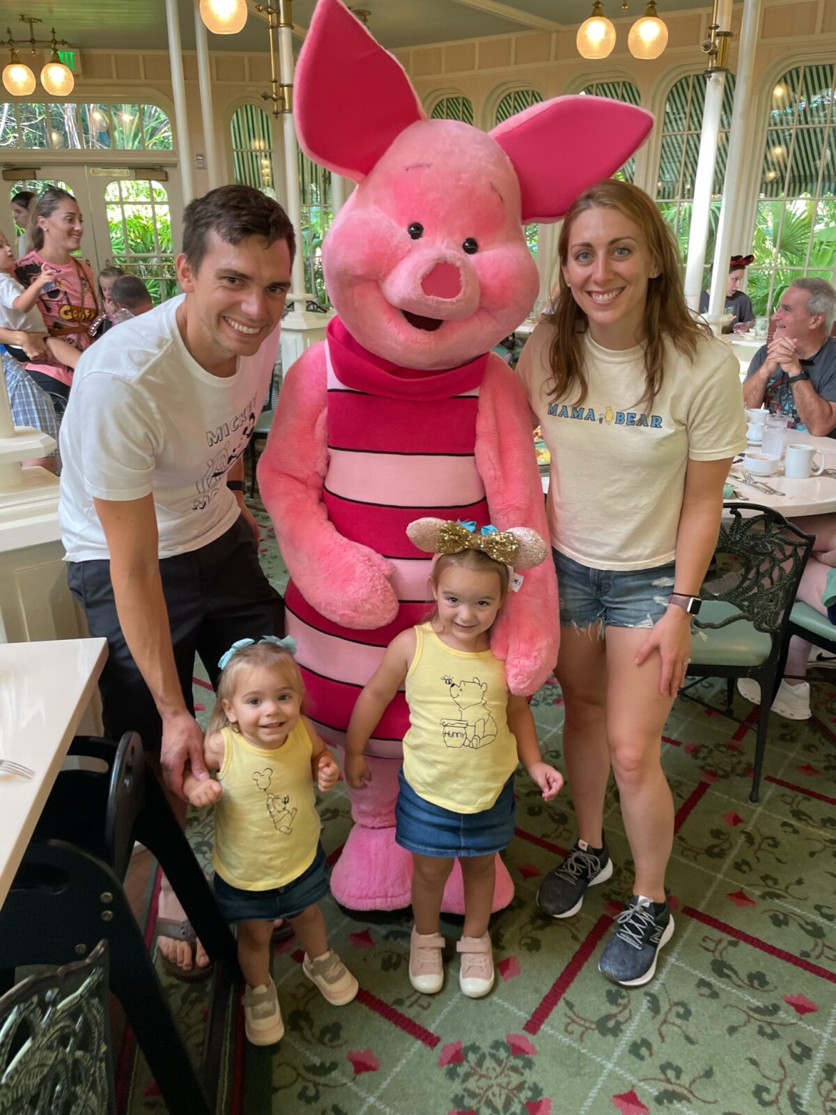 Piglet with husband and wife and two young daughters at character breatfast at Disney World