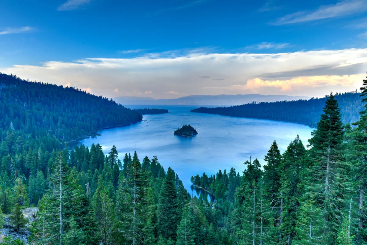 blue lake with green trees surrounding in Lake Tahoe