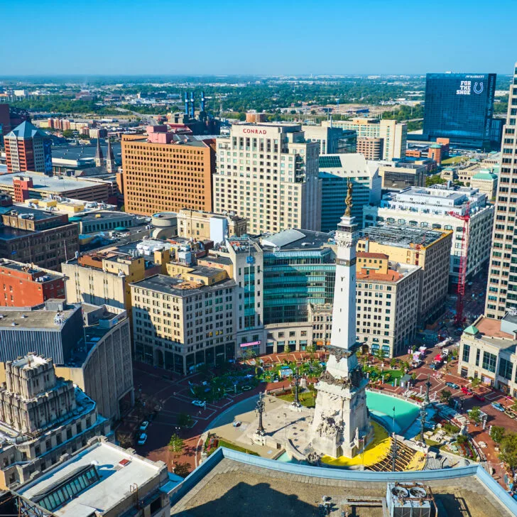 skyview photo of Indianapolis, Indiana. SHowing business buildings, the circle monument, Lucas Oil stadium in the background