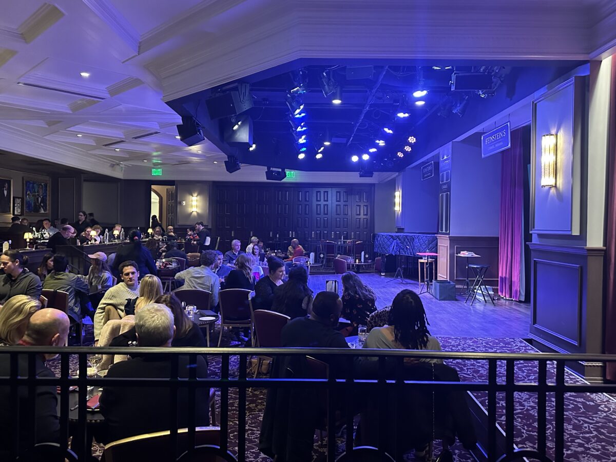 Inside Feinstein's at Hotel Carmichael. Crowd of people sitting at tables. Stage upfront.