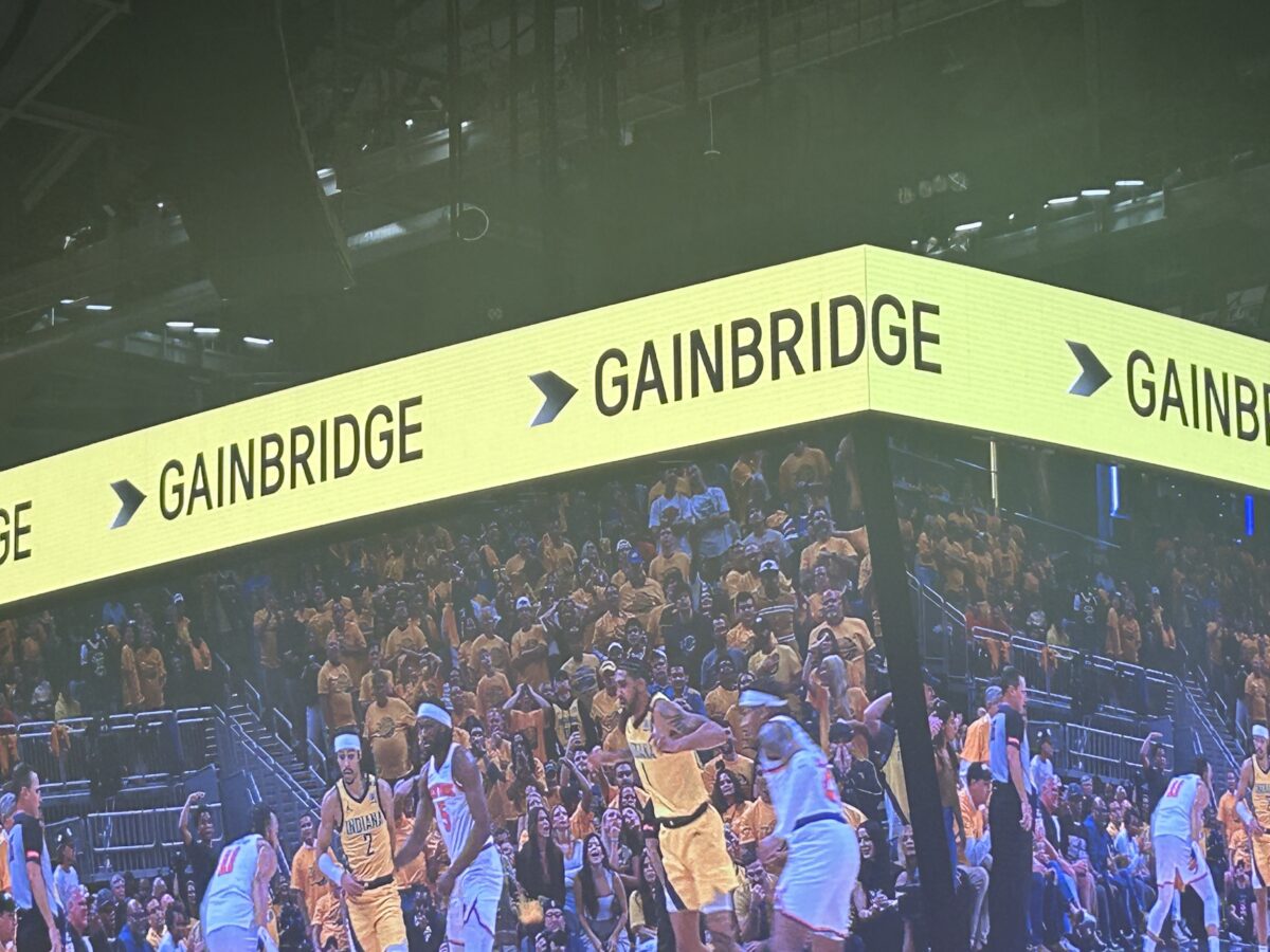 Inside Gainbridge Fieldhouse with a view of large screen monitor displaying a Pacer's game