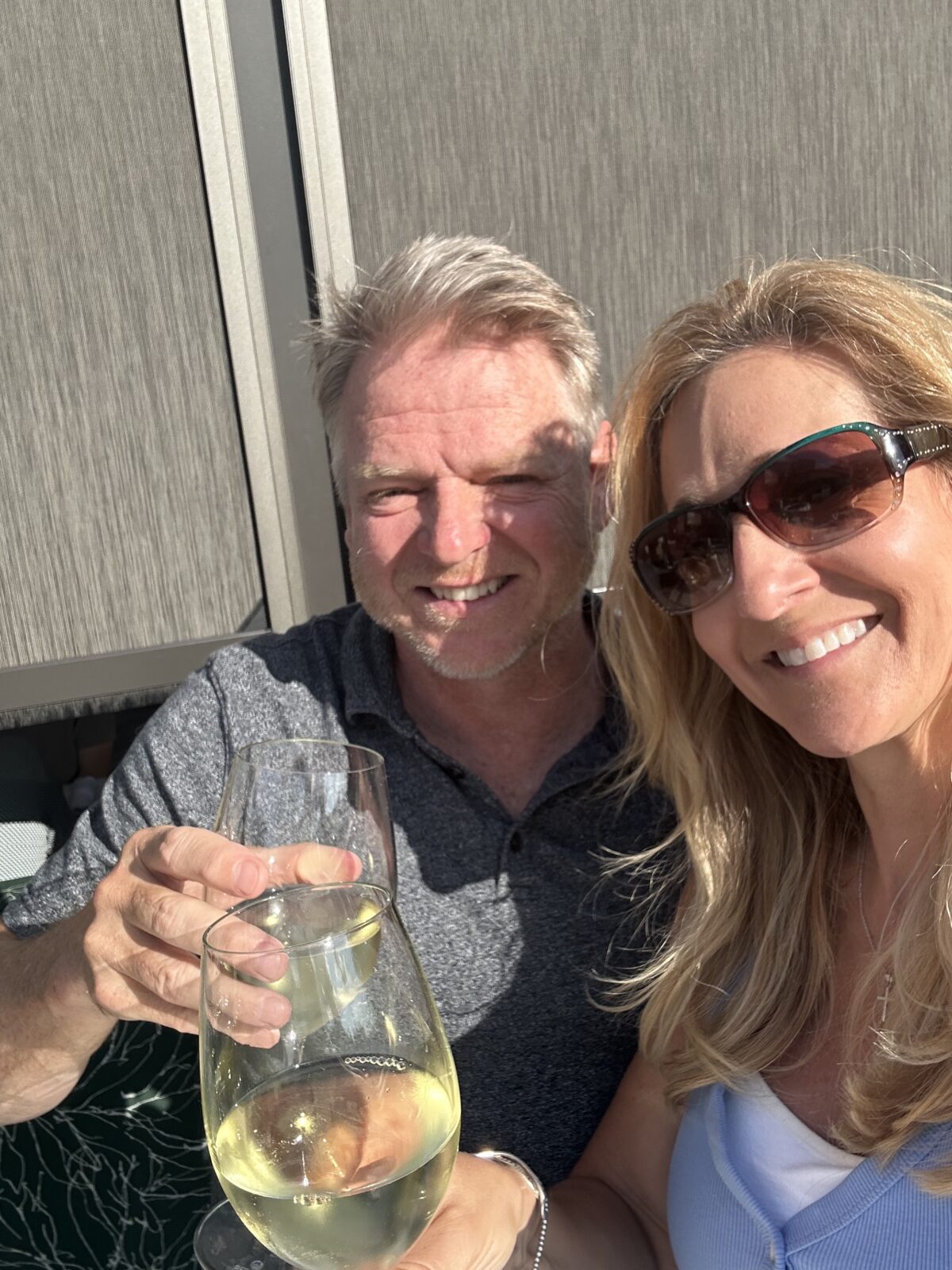 Man and woman couple toasting with a glass of white wine