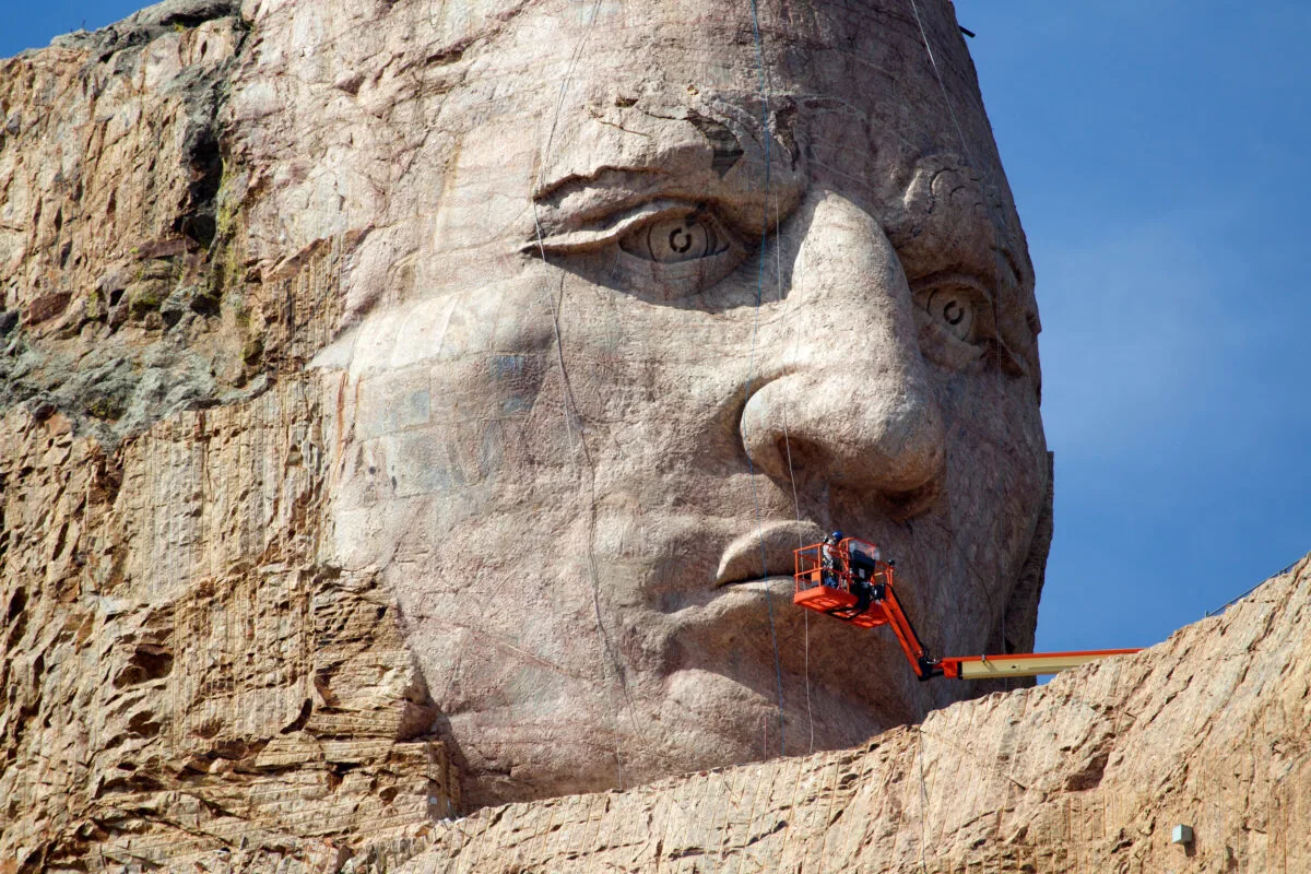 Crazy Horse memorial with people working on the monument