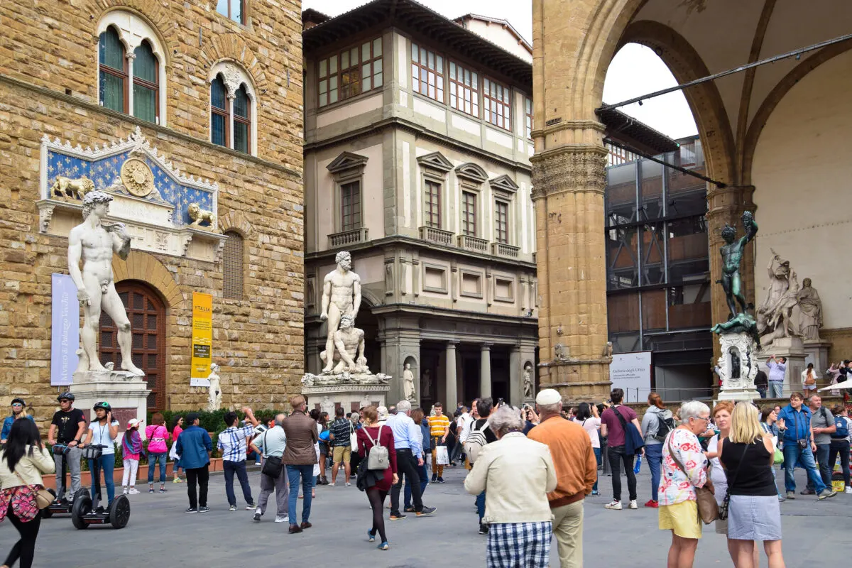 Very busy day at Piazza della Signoria in Fkorence Italy. Pedestrians roaming the streets