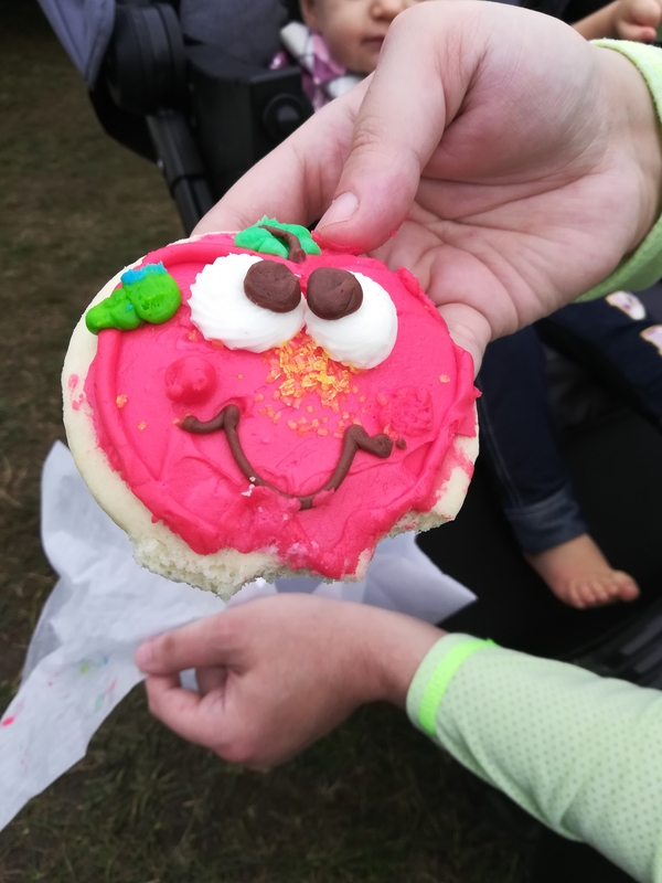 cookie decorated as a smiley face apple