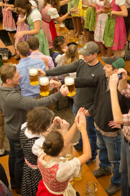 group of 30 year olds drinking beer at Oktoberfest