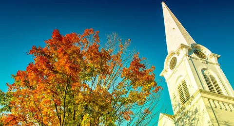 Manchester Vermont downtown church with a tree with red leaves