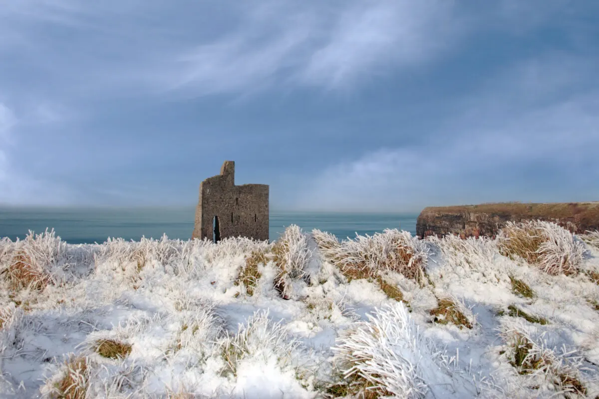 Snowy landscape in Ireland overlooking the Atlantic Ocean and Ballybunion Castle