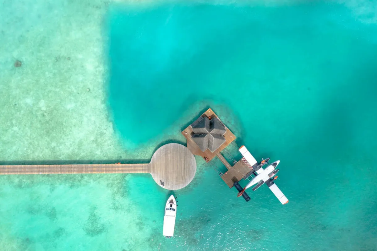 crystal blue waters with a bungalow and charter plane