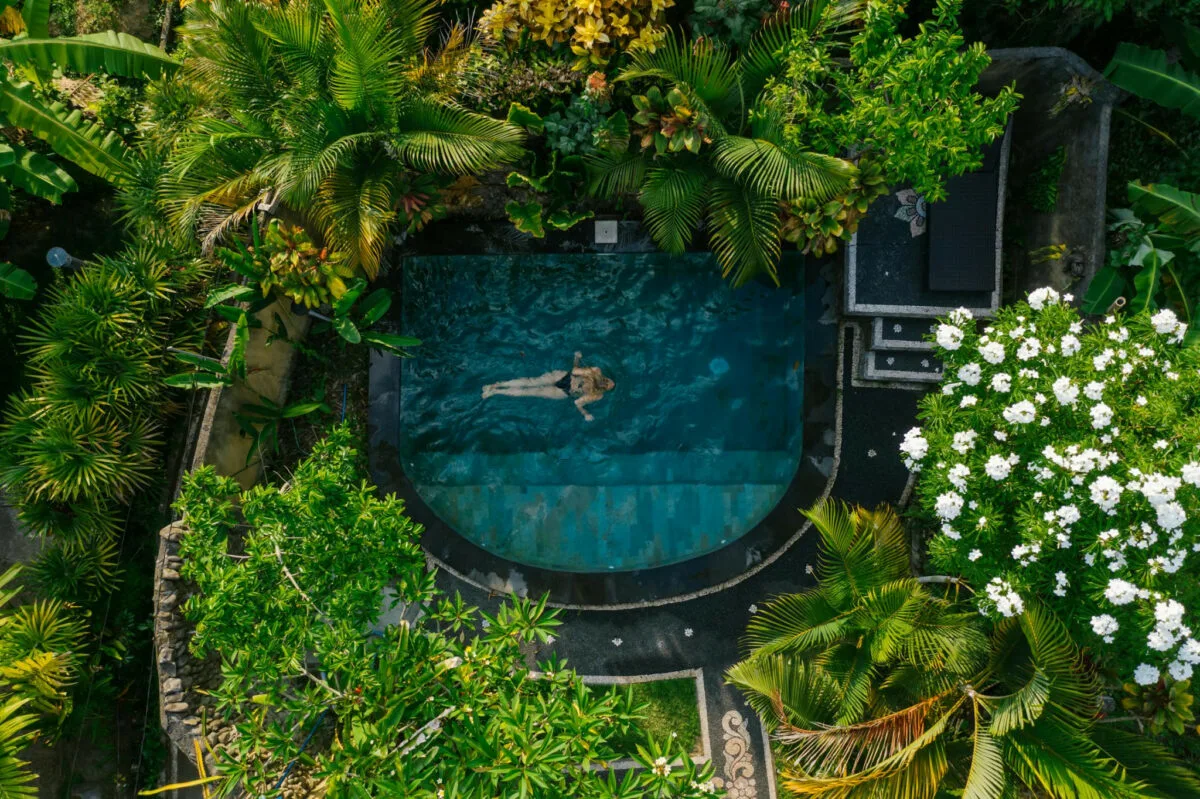 woman bathing in a hot tub in a tropical rainforest