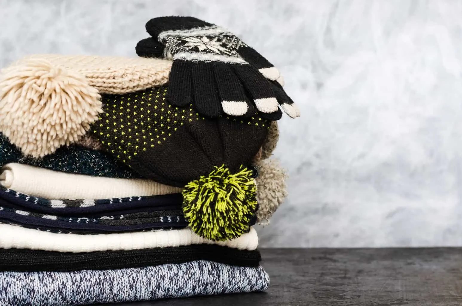 A winter scarf, hat and gloves laid out for travel