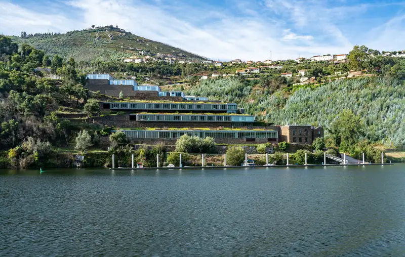 green mountains with modern building overlooking the Douro Valley river in Portugal