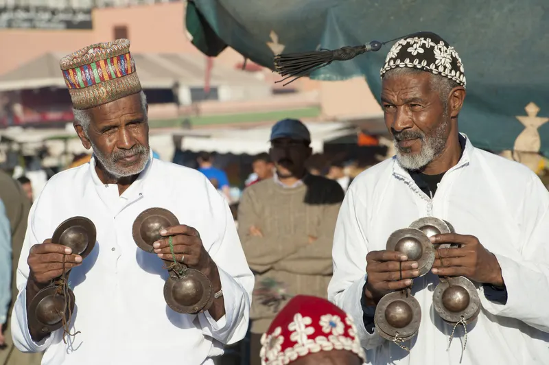 two moroccan men selling trinkets at a market