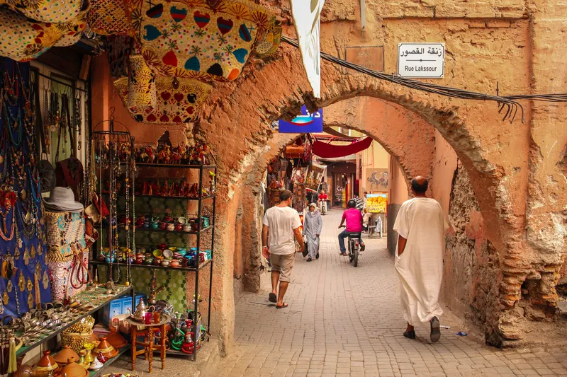 souk in Morocco with people walking around and beautiful trinkets for sale