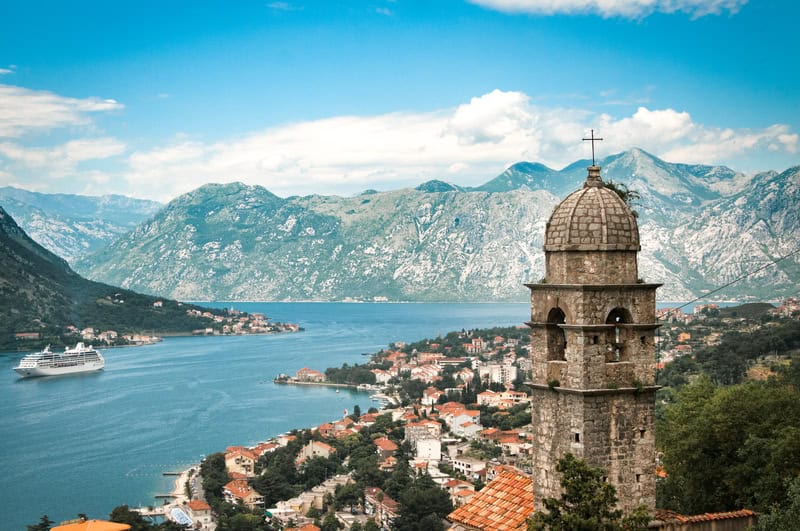 church and small town in Montenegro looking out over water and mountains