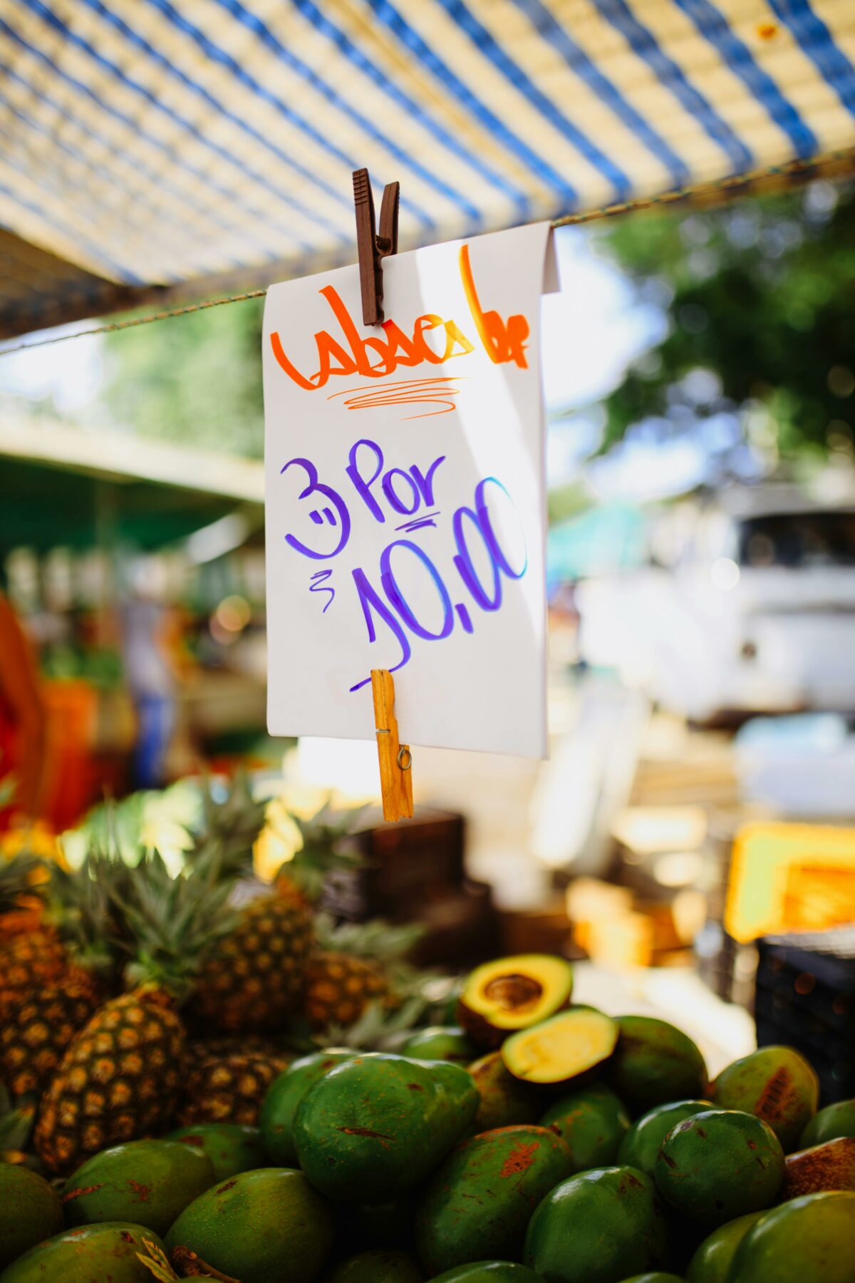 latin fruit stall selling avocado and pineapple