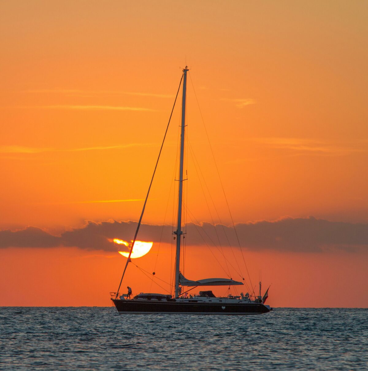 sailboat out on the ocean at sunset